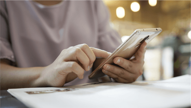 woman using smartphone cafe